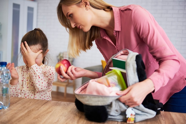 Displeased preparing her daughter for school