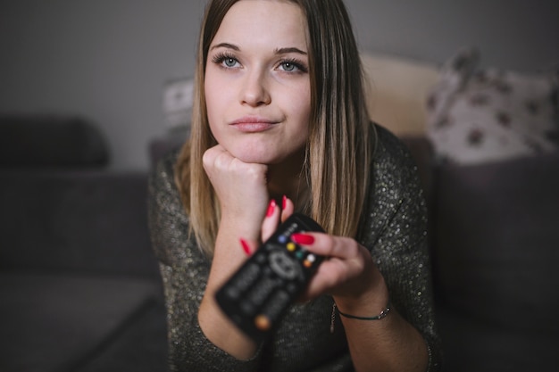 Photo displeased woman switching tv channels