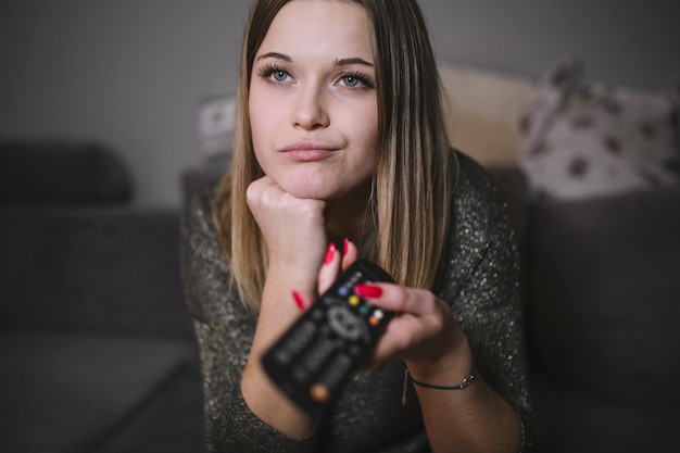 Displeased woman switching TV channels