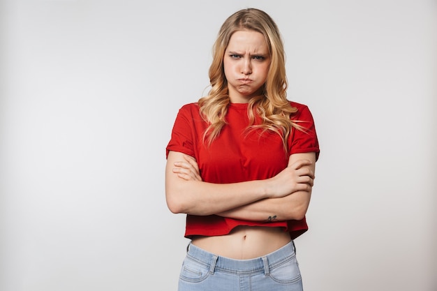 displeased young pretty beautiful woman posing isolated over white wall