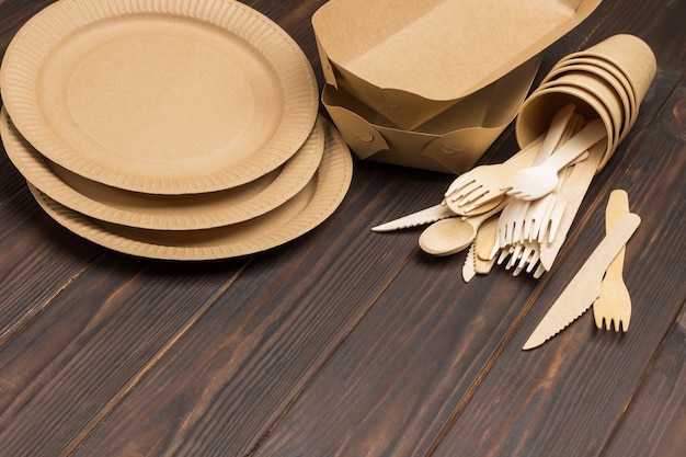 Disposable cardboard dishes. Wooden forks and spoons. Eco-friendly dish.