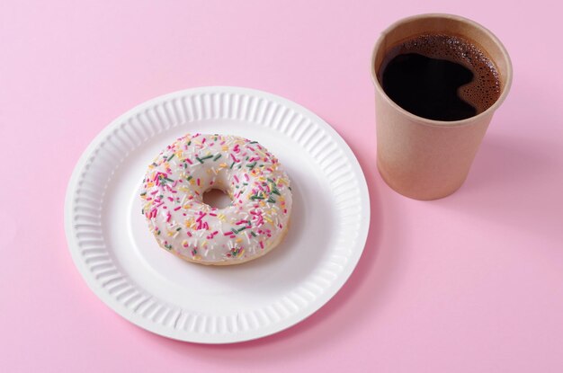 Disposable coffee cup and donut