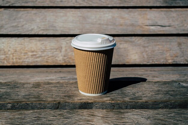 Disposable coffee cup on a wooden surface