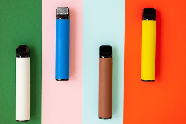 Disposable electronic cigarettes on color background