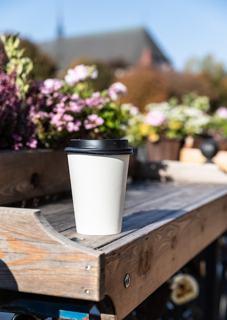 Disposable paper cup with coffee takeaway drink empty space for\
text mockup