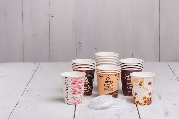 Disposable paper cups for coffee to go on wooden table