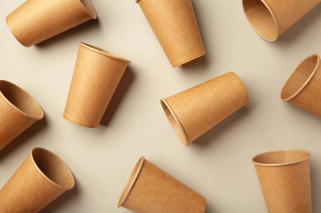 Disposable paper cups on grey background. Coffee concept.