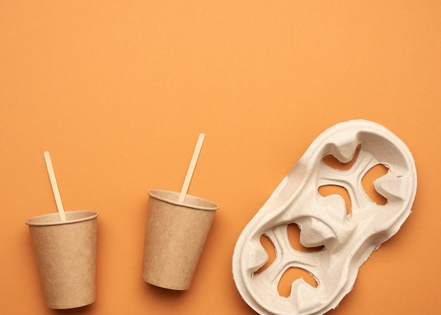 Disposable paper cups and recycled paper cup holders