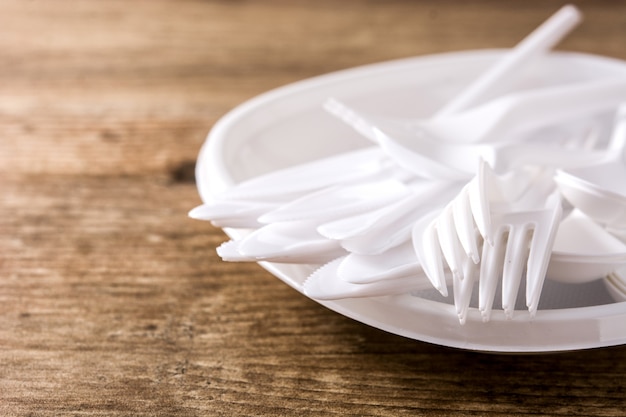 Disposable plastic crockery on wooden