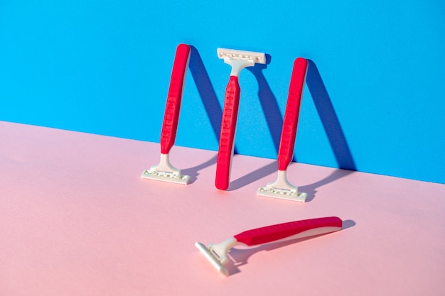 Disposable razor on blue and pink background