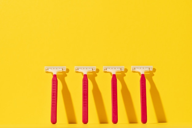 disposable razor tools on yellow background