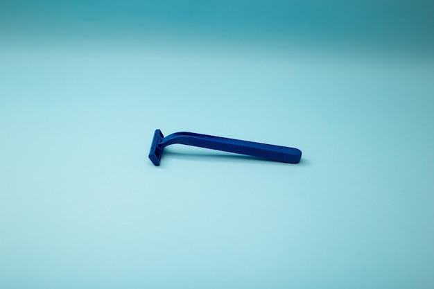 Disposable shaver razor isolated on blue background