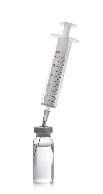 Disposable syringe with needle and vial on white background