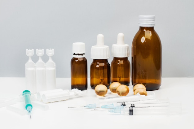 Photo disposable syringes and medical bottles on a white table