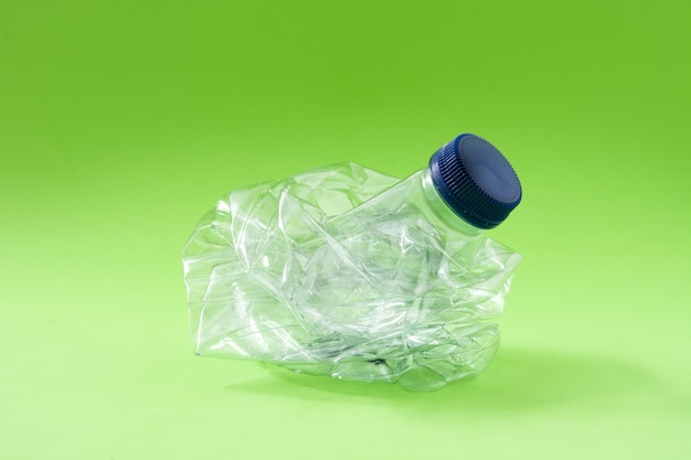 Disposable waste plastic bottle on green