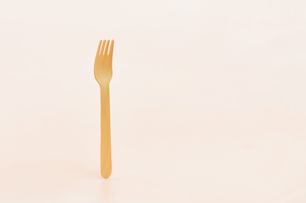 Disposable wooden cutlery forks in hand. 