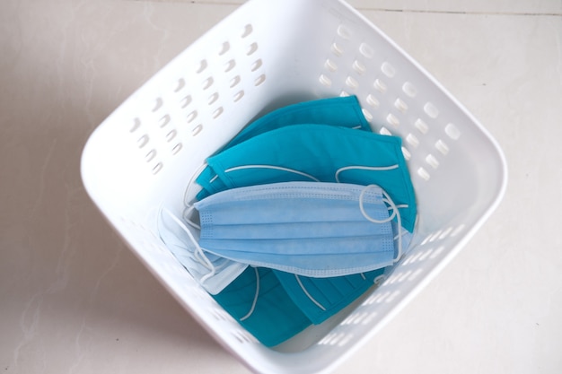 dispose the medical face mask and gloves in a bin, top view