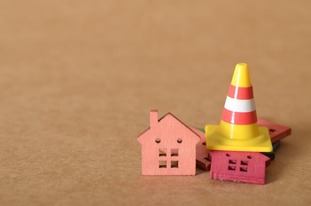 Disruption in Housing Yellow Cone and Wooden Houses Representing Urban Hazards