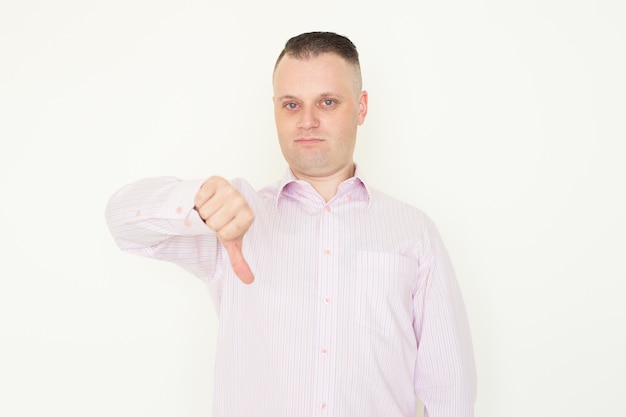 Dissatisfied boss showing thumb down while giving assessment to employee or product.