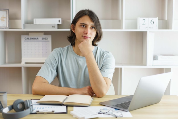 Distance education concept Teen boy studying maths online with teacher on video call at home