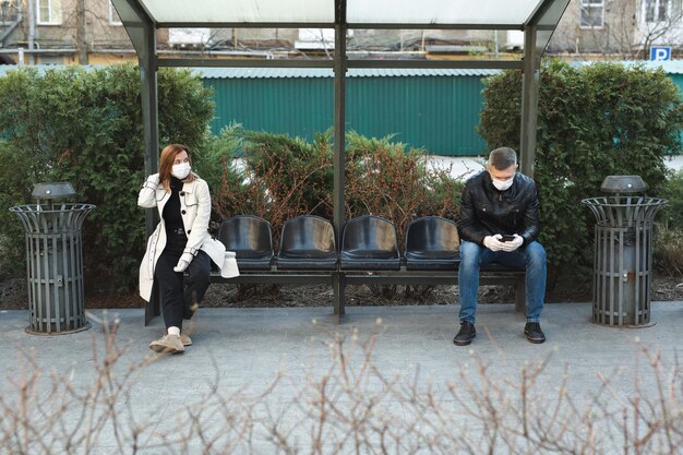 Distance between a man and a woman at a bus stop during a coronavirus epidemic. Covid 19.