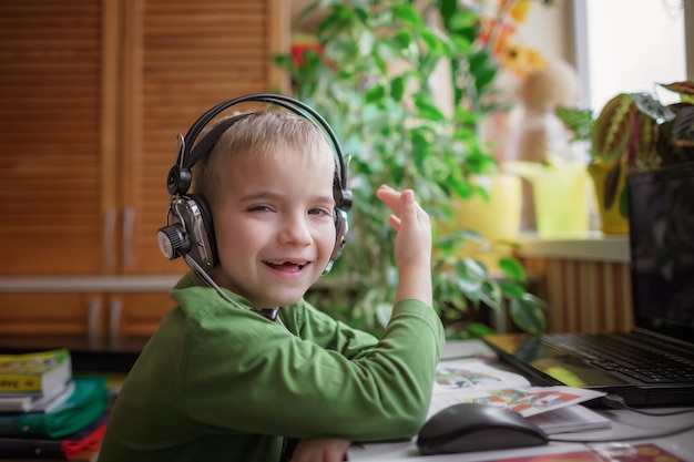 Distant education cute schoolchild studying homework during online lesson at home social distance