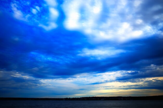 Distant land covered by blurry clouds landscape background