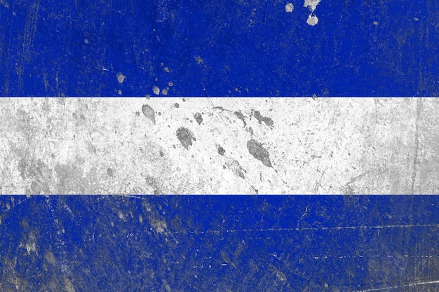 Distressed el salvador flag on an old abandoned concrete wall surface