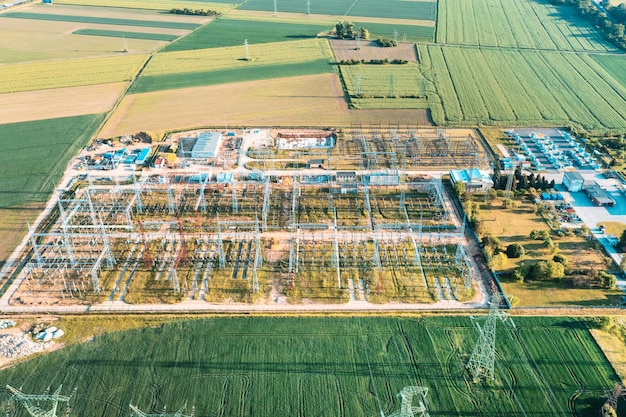 Distribution substation in the middle of the field power plant and many power lines Aerial view