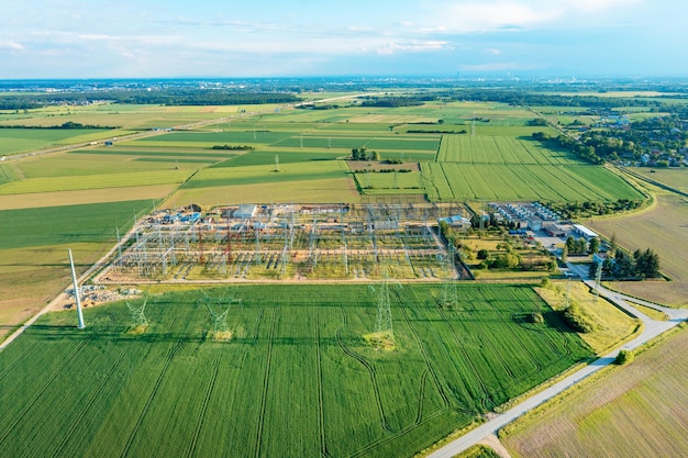 Distribution substation in the middle of the field power plant and many power lines Aerial view