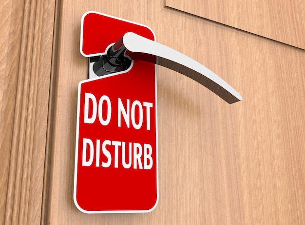 Photo do not disturb sign on a hotel door handle