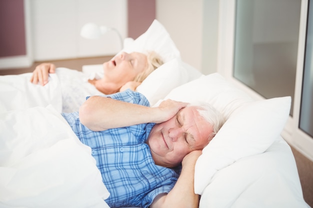 Disturbed man because his wife is snoring