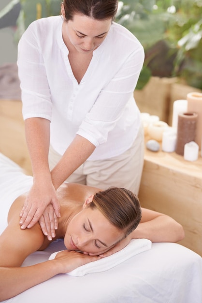 Dit is perfecte ontspanning Een aantrekkelijke jonge vrouw die een massage heeft in de spa