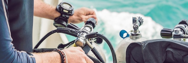 Diver prepares his equipment for diving in the sea BANNER, long format