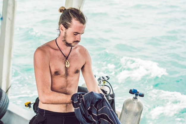 Photo diver prepares his equipment for diving in the sea