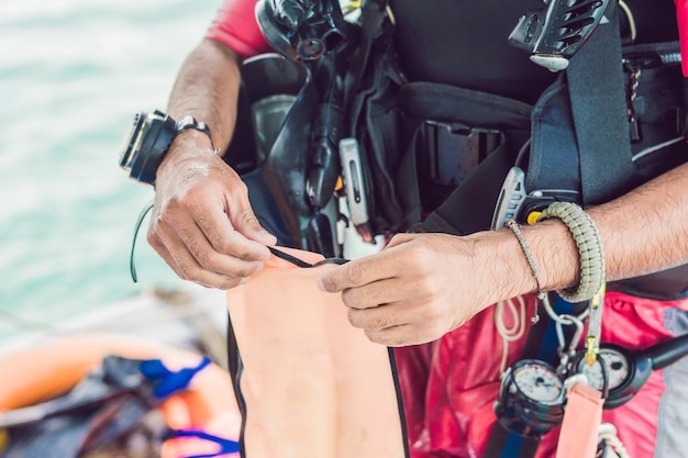 Diver prepares his equipment for diving in the sea