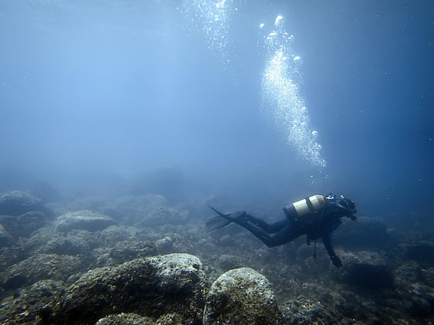 Diver Underwater scuba diver swimming under water