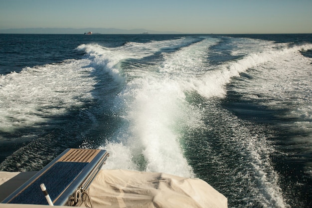 Diverging waves from a fast moving yacht, sea waves splashing, yacht track