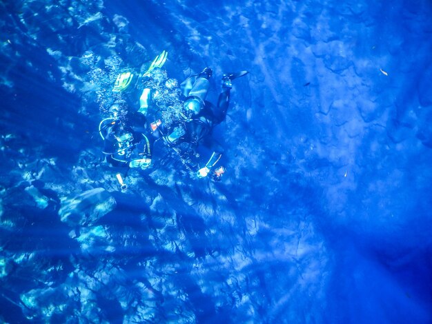 Divers in blue water lagoon