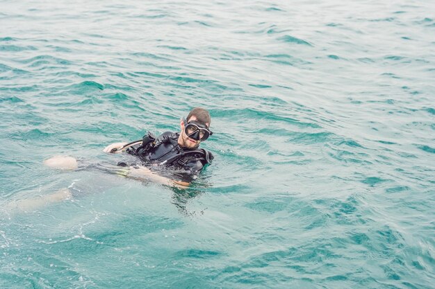 Divers on the surface of water ready to dive