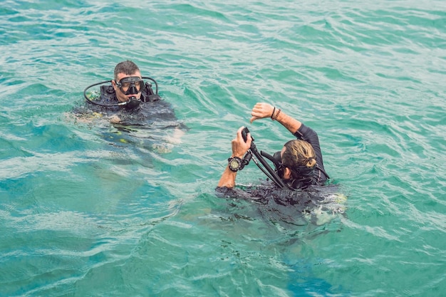 Divers on the surface of water ready to dive