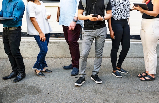 Diverse business people playing on digital devices