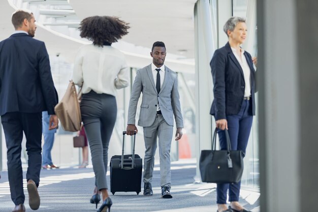 Diverse business people walking in corridor in modern office