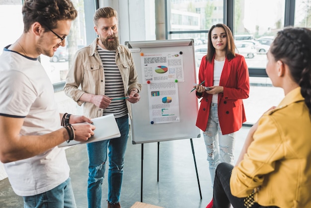 Diverse business team creating presentation in light workspace