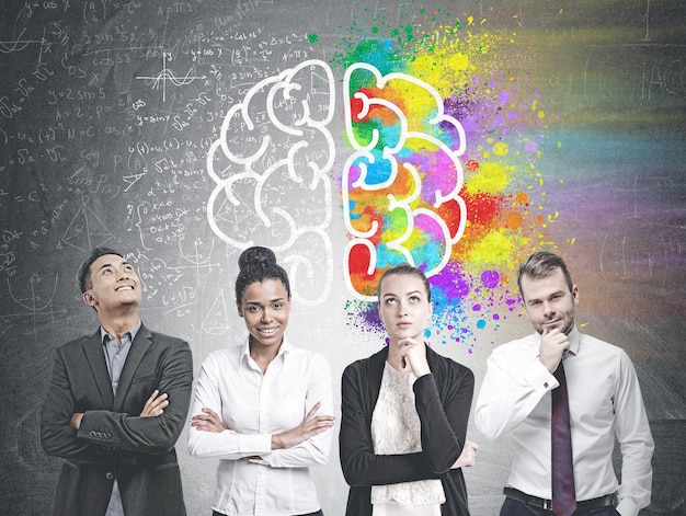 Photo diverse business team members standing in a row. a blackboard with a colorful brain sketch and formula