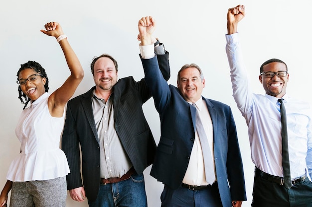 Photo diverse business team raising hands up in the air