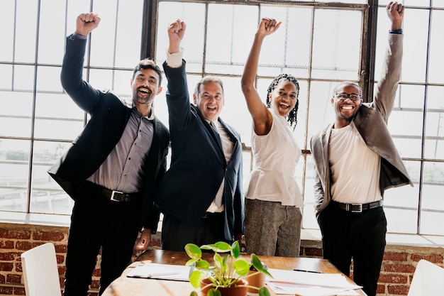 Photo diverse business team raising hands up in the air