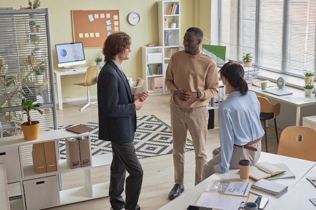 Diverse business team of three people discussing work project