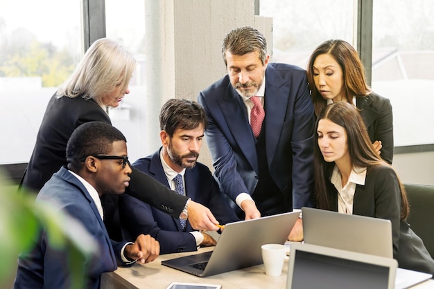 Diverse colleagues analyzing data in office