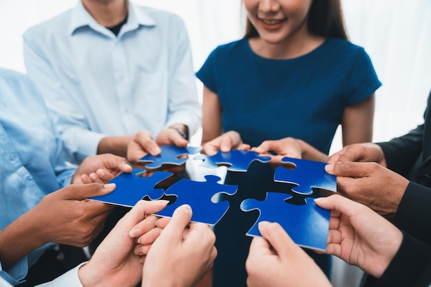 Diverse corporate officer workers connecting puzzle pieces Concord